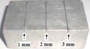 174 5.2.1 RESULTADOS DE DETECCIÓN DE DISCONTINUIDADES Para esta prueba se utiliza un bloque de aluminio con fisuras de 1, 2 y 3 mm de profundidad, que se muestra en la Figura 5.