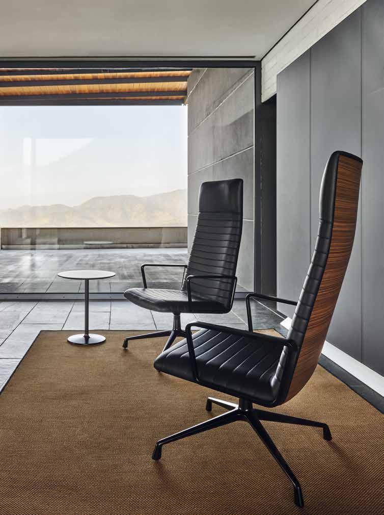 b BU 1894* High back lounge chair. Upholstered shell. Aluminium swivel base with central column and four-star foot, with self return system and Black finish. Back finish in Walnut veneer.