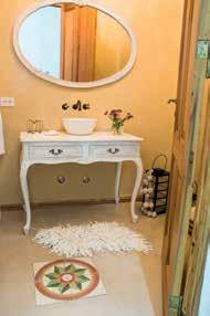 El baño en suite se terminó con estucado en las paredes y piso de microcemento con incrustaciones calcáreas.