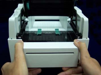Abra la unidad mecánica de impresión apretando los pivotes verdes