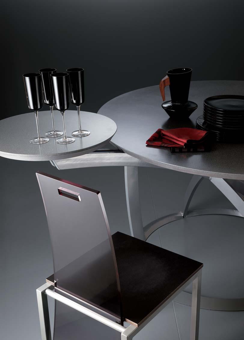 FLUX round table: metallic grey varnished metal frame with fixed Cristalan or Quarz top, available in various colours, with substrate in Grey lacquered fibre board with slanted edge.