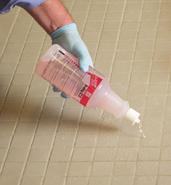 Wipe disinfectant from the spill area with the