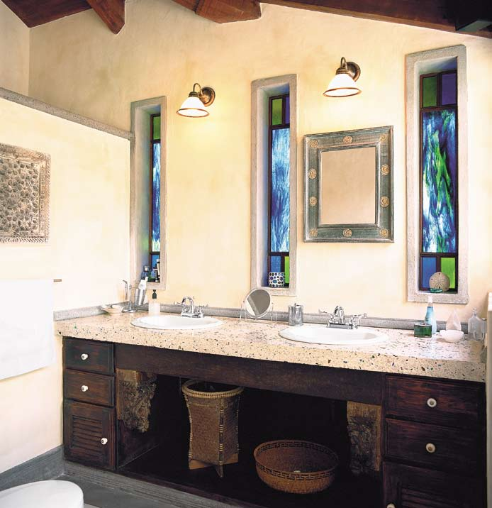 El baño está diseñado para que reciba tres fuentes de luz: la natural que ingresa de forma lateral, la puntual procedente de los apliques en la pared, y la que se filtra por los vitrales en tonos