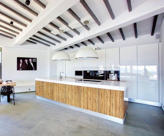 Minimalismo en la cocina La cocina, abierta y despejada, es todo un ejemplo de minimalismo. En esta estancia se ha optado por dejar a la vista las vigas del techo.